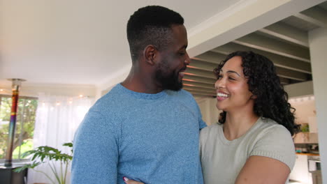 happy couple embracing and laughing together at home, enjoying thanksgiving moments