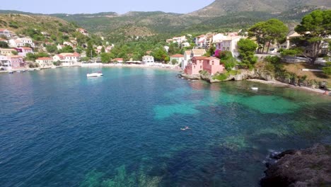 tourist swimming in the crystal clear blue water of agriosiko beach, a secret getaway located in the isalnd of cephalonia in western greece