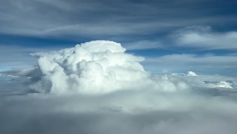 exclusive pilot point of view while overflying the top of a cumulonimbus during the cruise at 12000 metres high