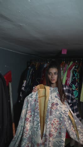 woman looking at kimono in a thrift store