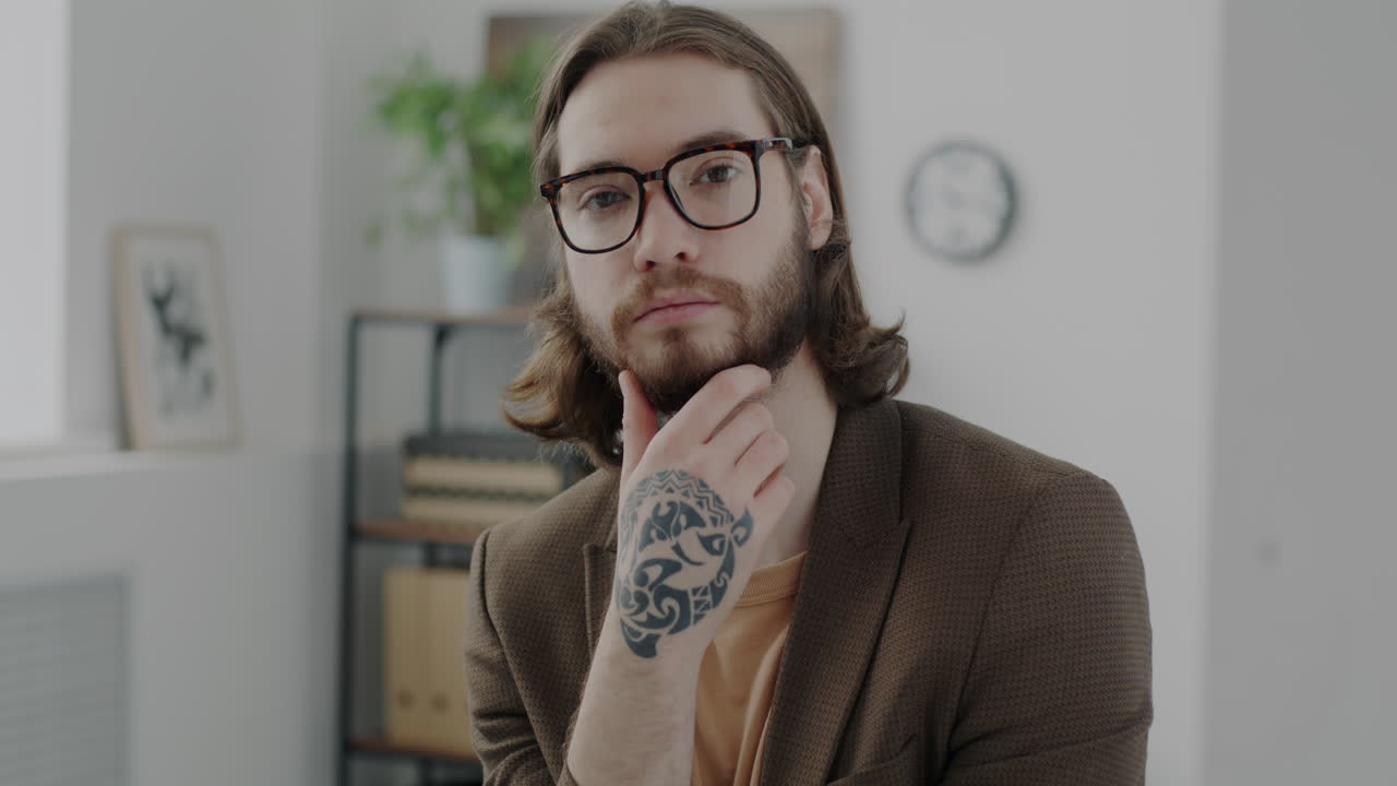 Man with a tattoo in a modern office setting