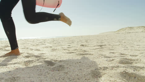 surfer with surfboard running on the beach 4k 4k