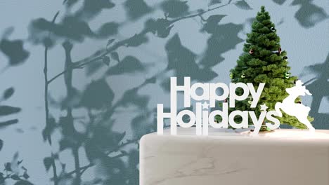 Small-Christmas-tree-with-"Happy-Holidays"-sign-on-marble-platform-with-blue-floral-shadow-background