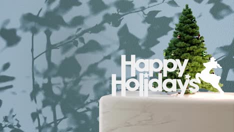 small christmas tree with "happy holidays" sign on marble platform with blue floral shadow background