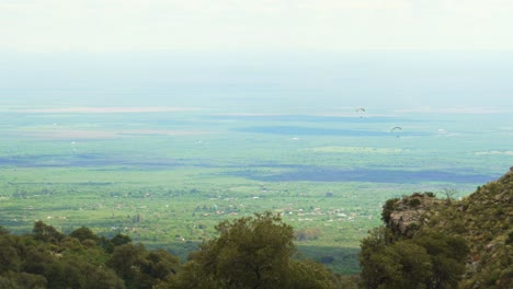 paragliders flying over the valley