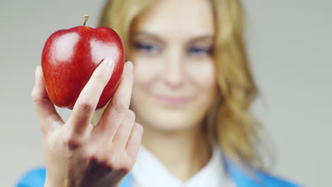 Close-Up-Of-A-Blue-Eyed-Woman-With-Red-Apple-Hd-Video