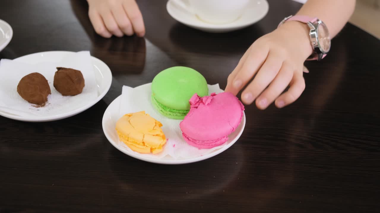 Girl Eating a Pink Macaroon
