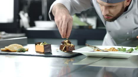 chef decorating cake in kitchen