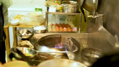 chef skillfully cooks with a wok in kitchen