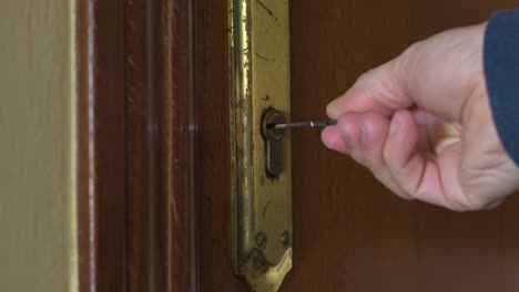 hand with a key closing the house door