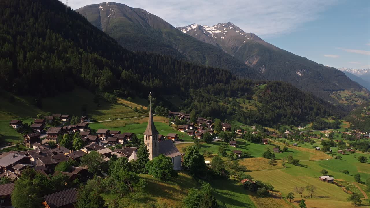 A peaceful aerial view of a small village with a church nestled in the mountains of Norway
