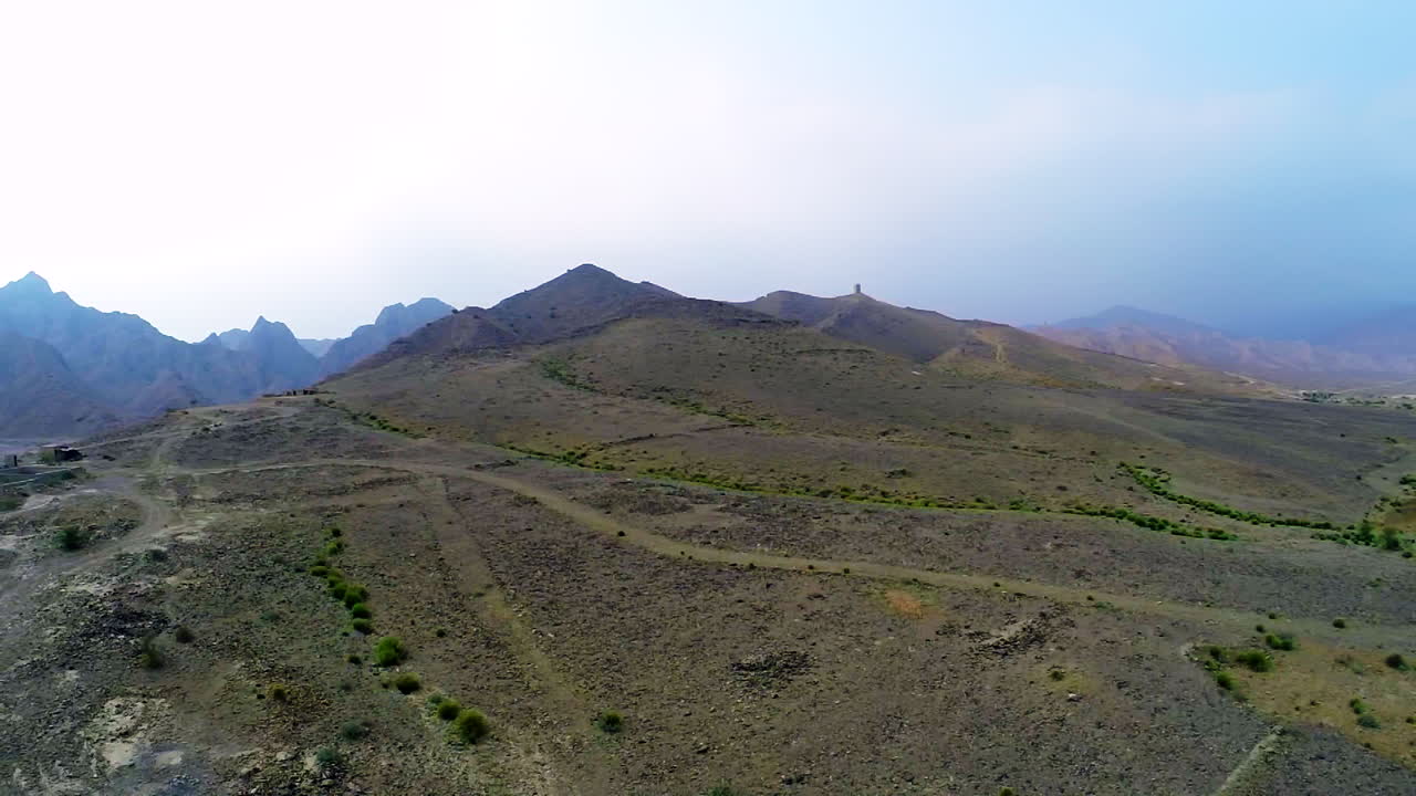 alejándose de las majestuosas montañas, caminos y casas cerca de la colina