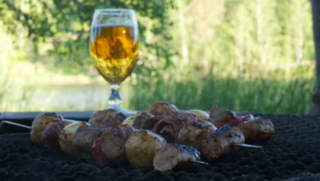 Meat-and-vegetables-mixed-together-and-put-on-a-metal-stick-are-being-grilled-over-a-hot-coal-bbq