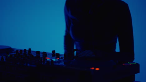 a female dj mixing music on a mixer