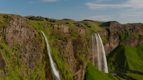 Birds-eye-of-Seljalandsfoss,-the-most-important-and-well-known-waterfall-in-Iceland.-Seljalandsfoss-is-a-waterfall-that-can-be-fully-encircled,-situated-on-the-South-Coast-with-a-drop-of-60-meters