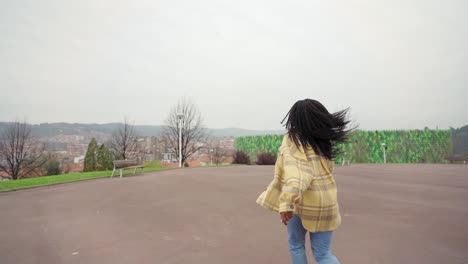 Cheerful-woman-listening-to-music-and-dancing-freestyle