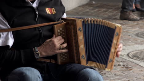 musician playing with accordion in public area