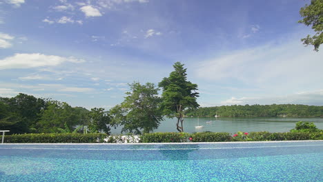 gorgeous view from pool on the edge of nature environment with a beautiful blue cloudy sky