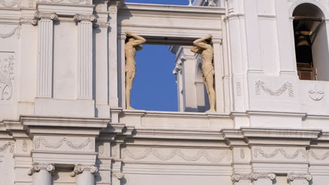 sculptured male statues hold window beam in leon cathedral, nicaragua