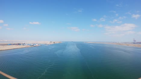 timelapse of a vessel entering and transitting the suez canal on a sunny day