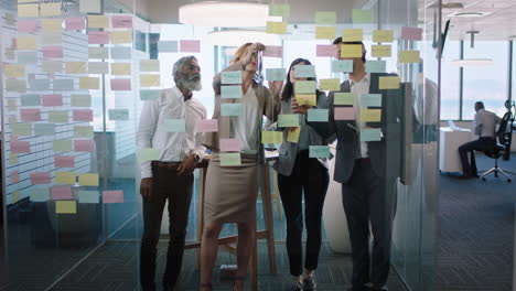 group-of-business-people-meeting-using-sticky-notes-brainstorming-colleagues-working-on-problem-solving-strategy-thinking-of-solution-for-project-in-corporate-office-4k