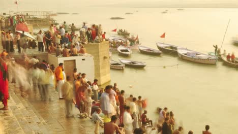 time lapse indian pilgrims rowing boat in sunrise. ganges river at varanasi india.