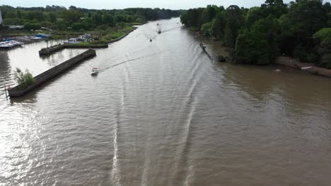 several motorboats navigating a tropical waterway in south america