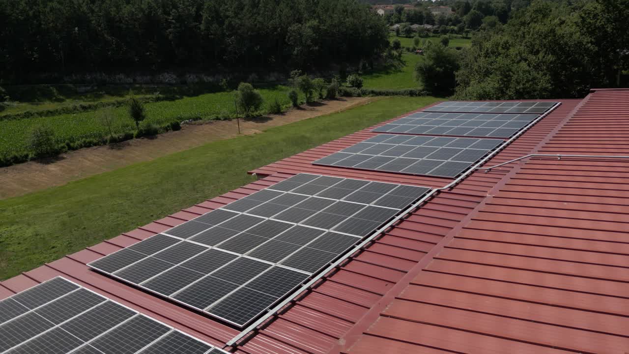 Rooftop solar panels capture sunlight in rural landscape with greenery in background