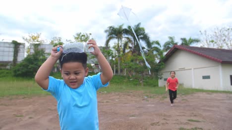 a child with a plastic bottle kite