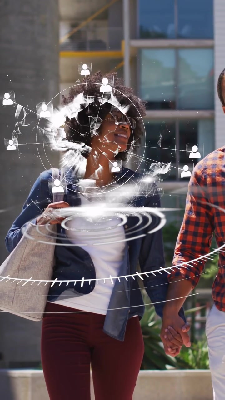 Vertical video: Couple walking on path, crop showing HUD burst over her forming AR net for tech