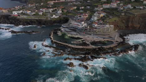 volcanic pools of porto moniz in madeira potrugal fottage with drone of cliffs, ocean, atural bathing spots, houses filmed at sunset