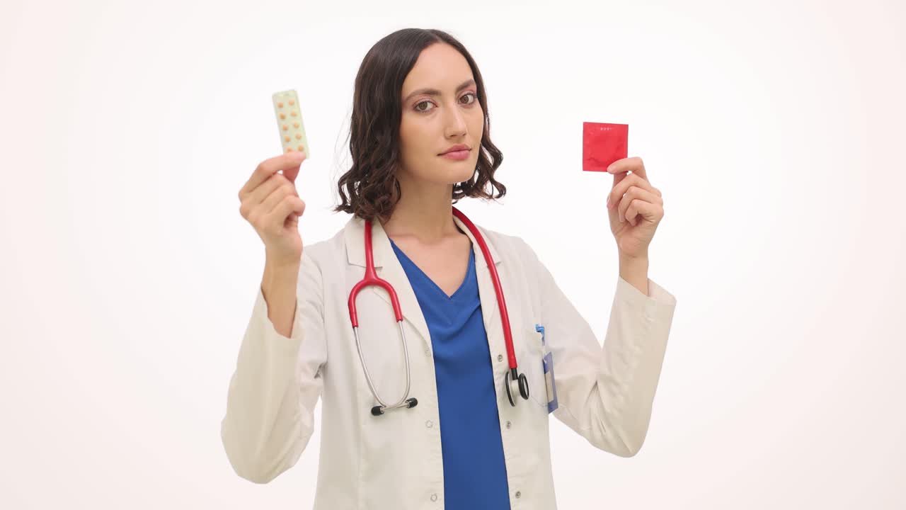 Doctor holding pills and condom