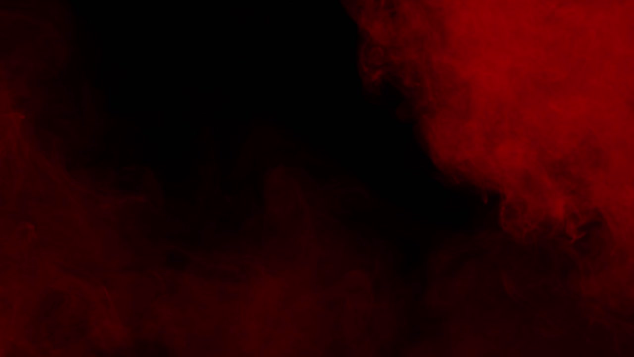 Red mist fog or smoke swirls and flows slowly on a black background. Ideal overlay for bloody horror films, dramatic intros, atmosphere of danger or passion