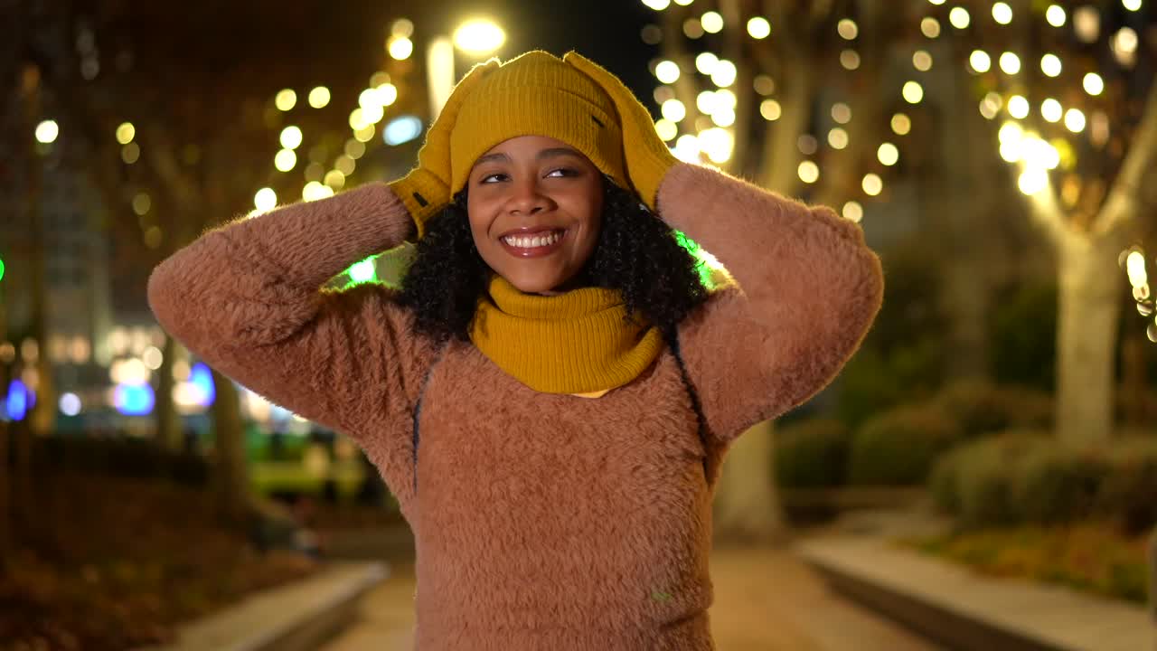Woman in Yellow Hat and Scarf at Night