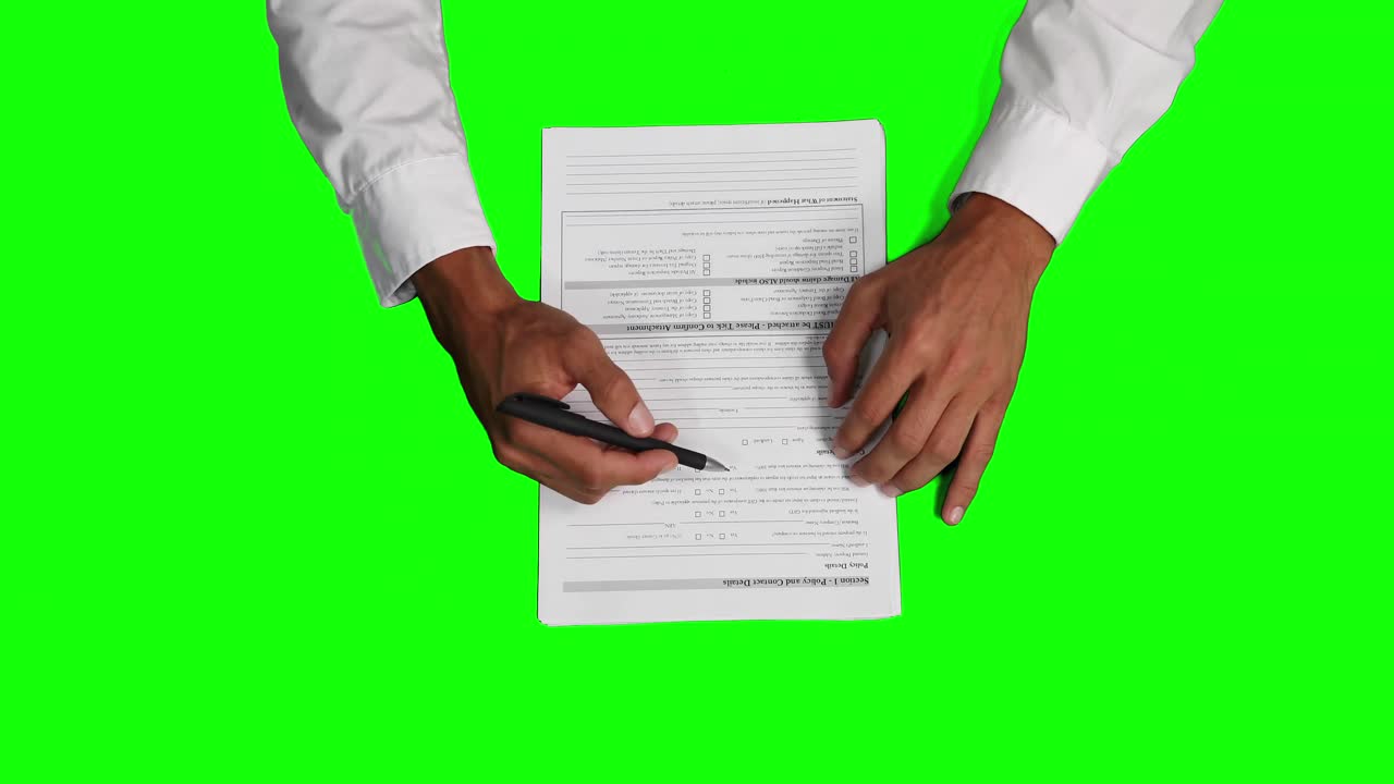 Overhead view of a Caucasian man explaining a paperwork with green screen