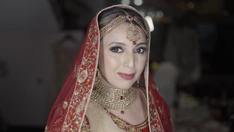 Attractive-Indian-Bride-Portrait-With-Traditional-Red-Veil-During-Wedding-Day