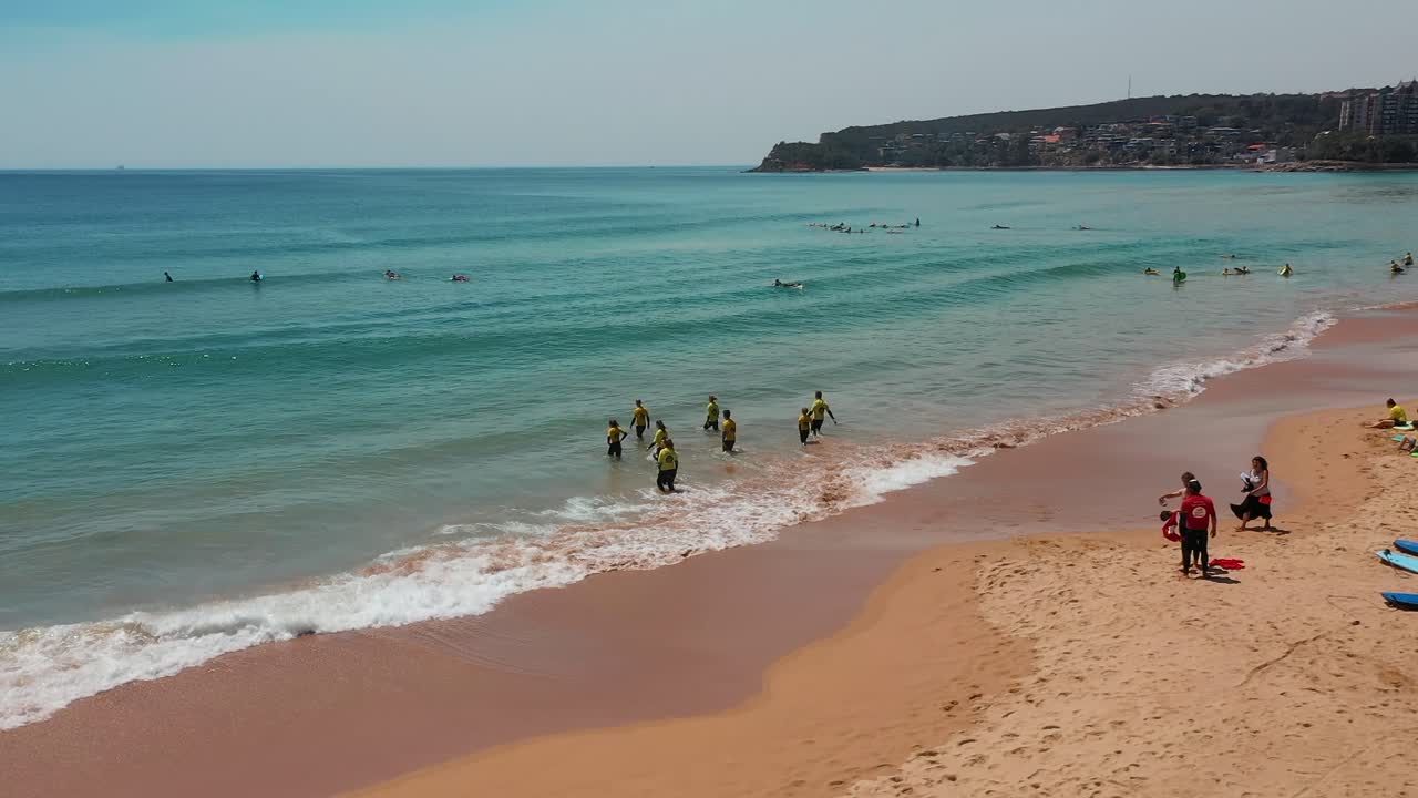 Surf School On The Beach About To Go Into The Ocean Tide For Their First Surf Lesson Tourist Vacation Aerial Video