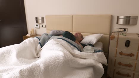 gay mature couple of men awaking in bed at home