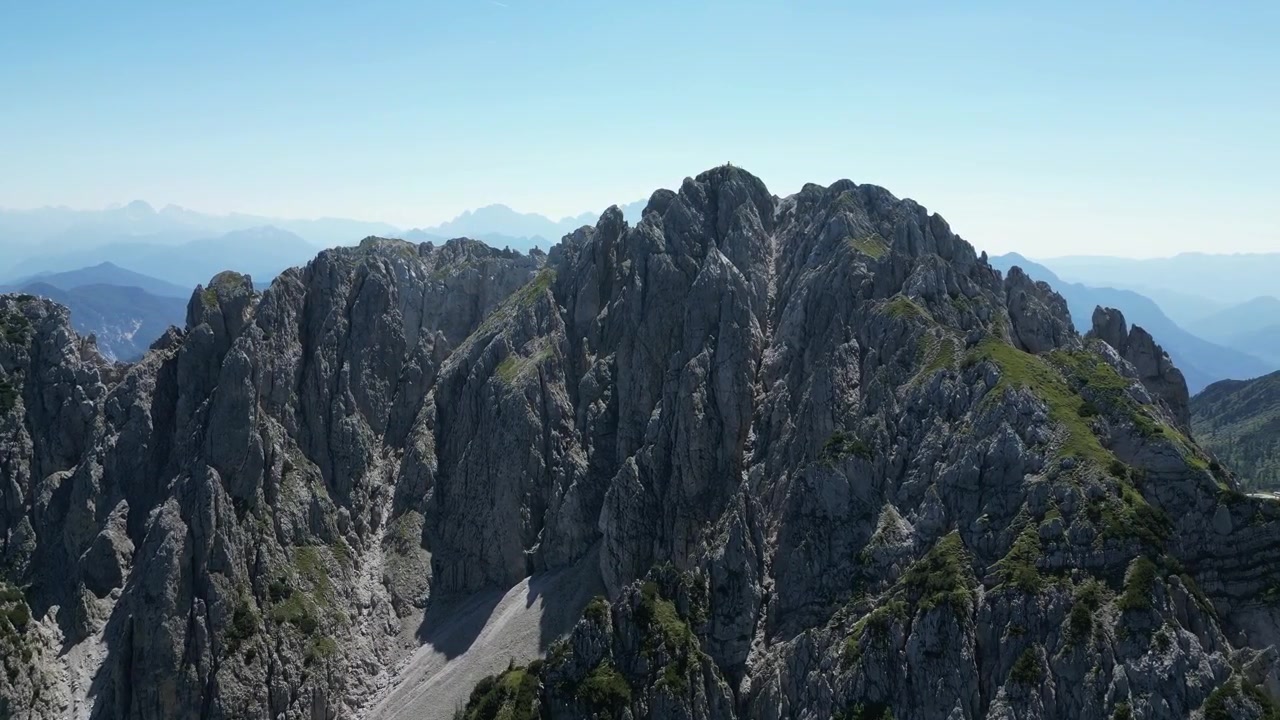 Aerial drone footage of Gartnerkofel, Austria: rugged limestone peaks, alpine ridges and expansive valleys surrounded by pristine mountain scenery. Ideal for nature, travel and outdoor projects.