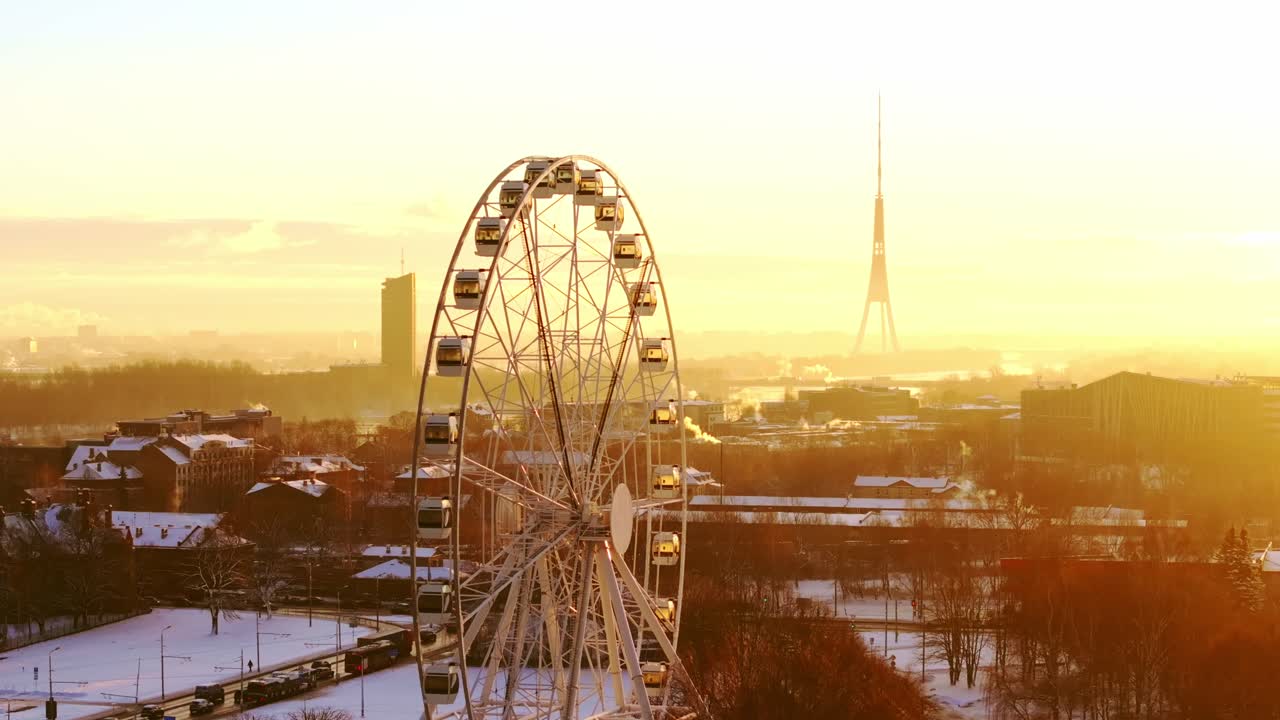 Vibrant sunrise of Ferris wheel and snowy urban streets, peaceful winter morning