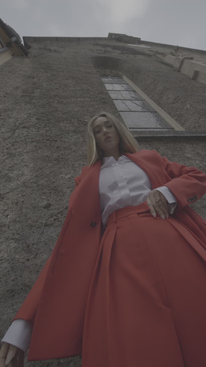 Stylish Woman in Red Suit in Front of Building