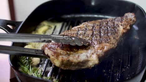 rib eye steak fried on hot pan 4k-1