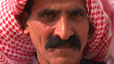 close up of a face of a palestinian bedouin man in headscarf 1