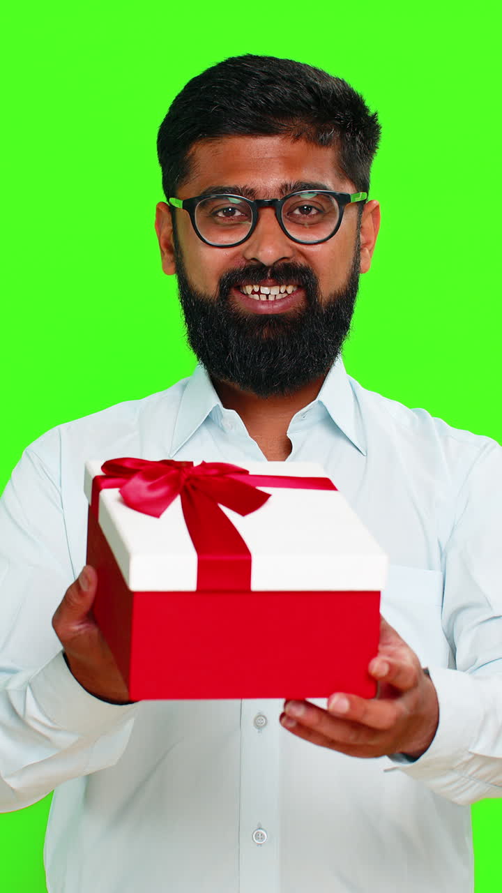 Indian man smiling offering gift birthday box kind gesture showing surprise happy giving present