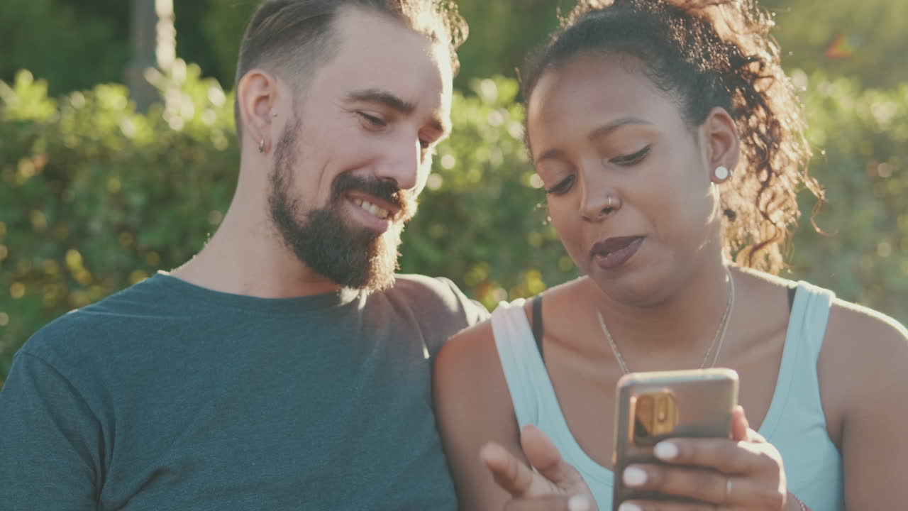Interracial couple using phone together