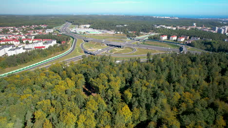 aerial - fast traffic road and large road intersection - in the background view of the city and the bay of gdansk in the city of gdynia, district gdynia redłowo