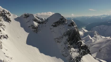 Cinematic-shot-of-a-skier-coming-down-the-mountain-in-British-Columbia,-Canada