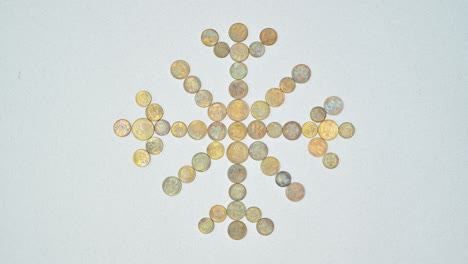 coins make snowflake for new year and christmas. stop motion