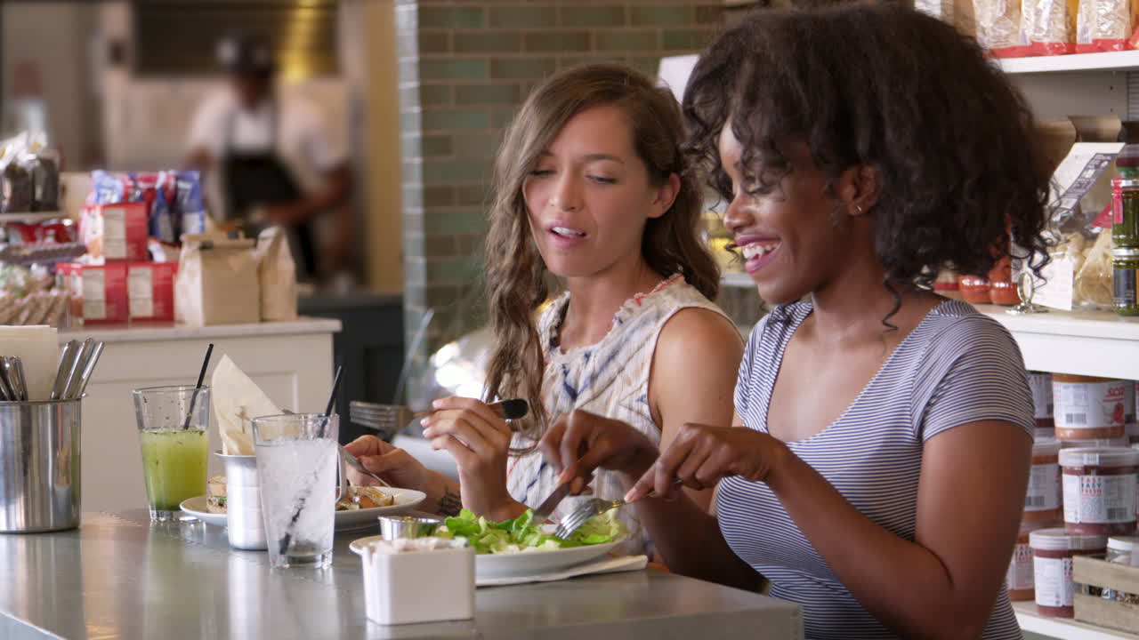 Female Friends Enjoying Lunch In Restaurant Shot On R3D