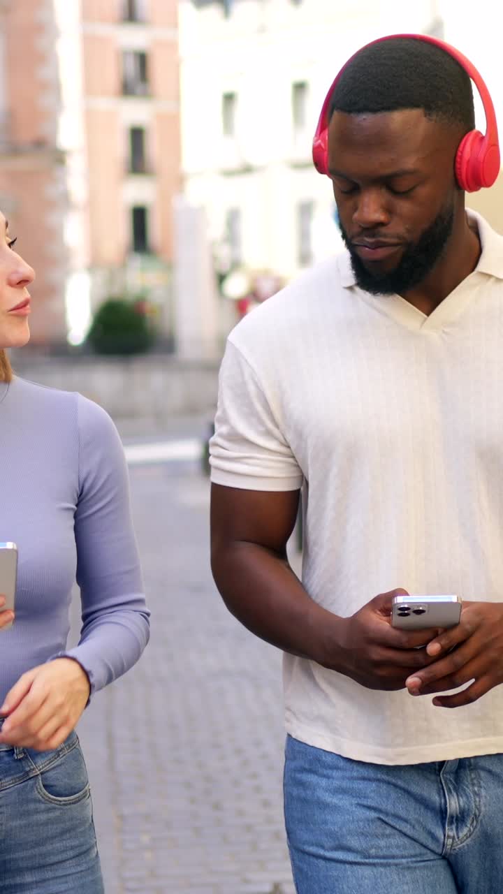 People with headphones and phone on the street